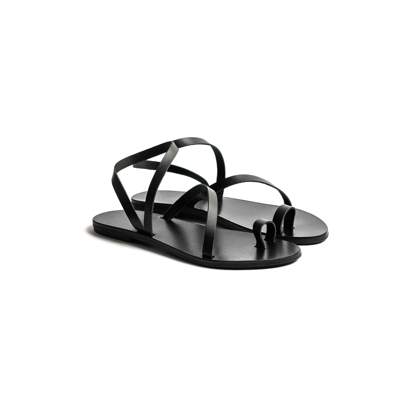Pair of flats sandals black against a white background. They are fancy black flats.