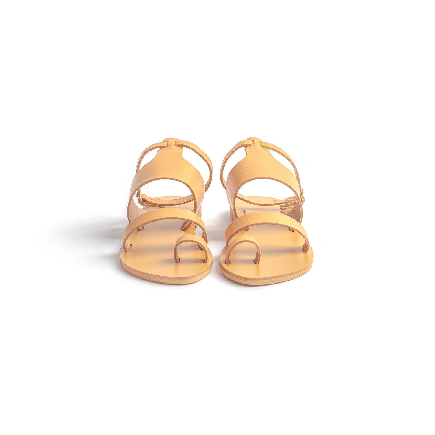 Front view of flat sandals with strap for women against a white background. They are flat sandals with ankle strap.