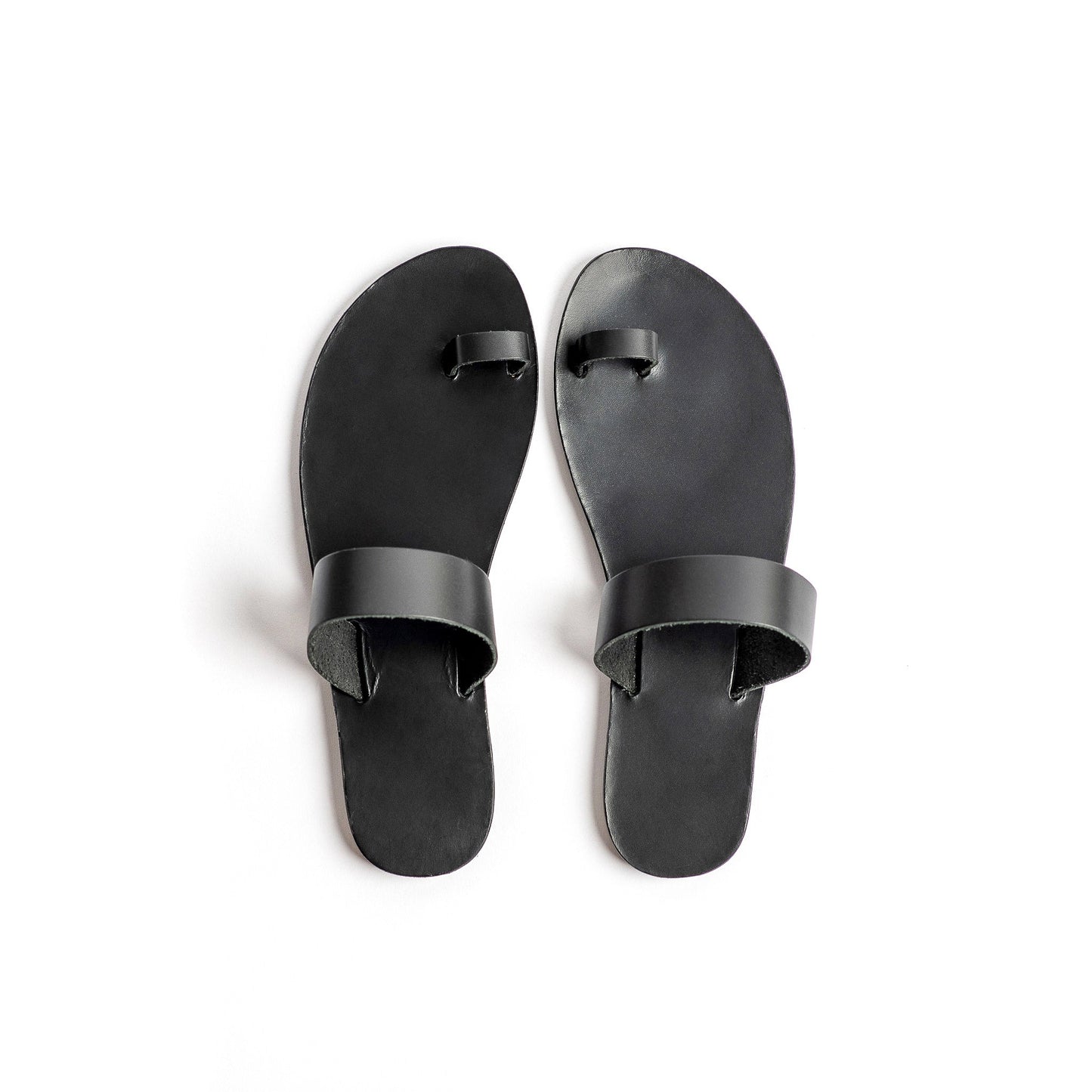 Top view of Astara ladies black flats against a white background.