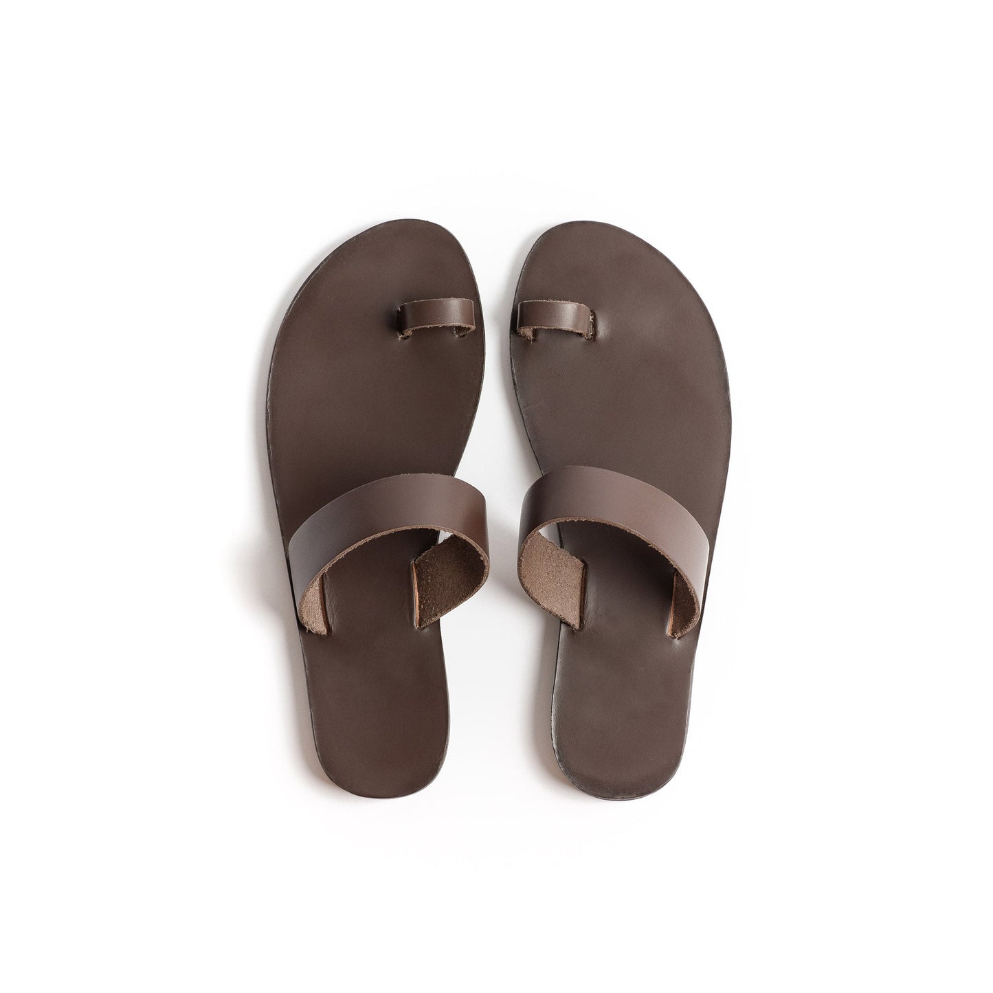 Top view of flat sandals brown against a white background.