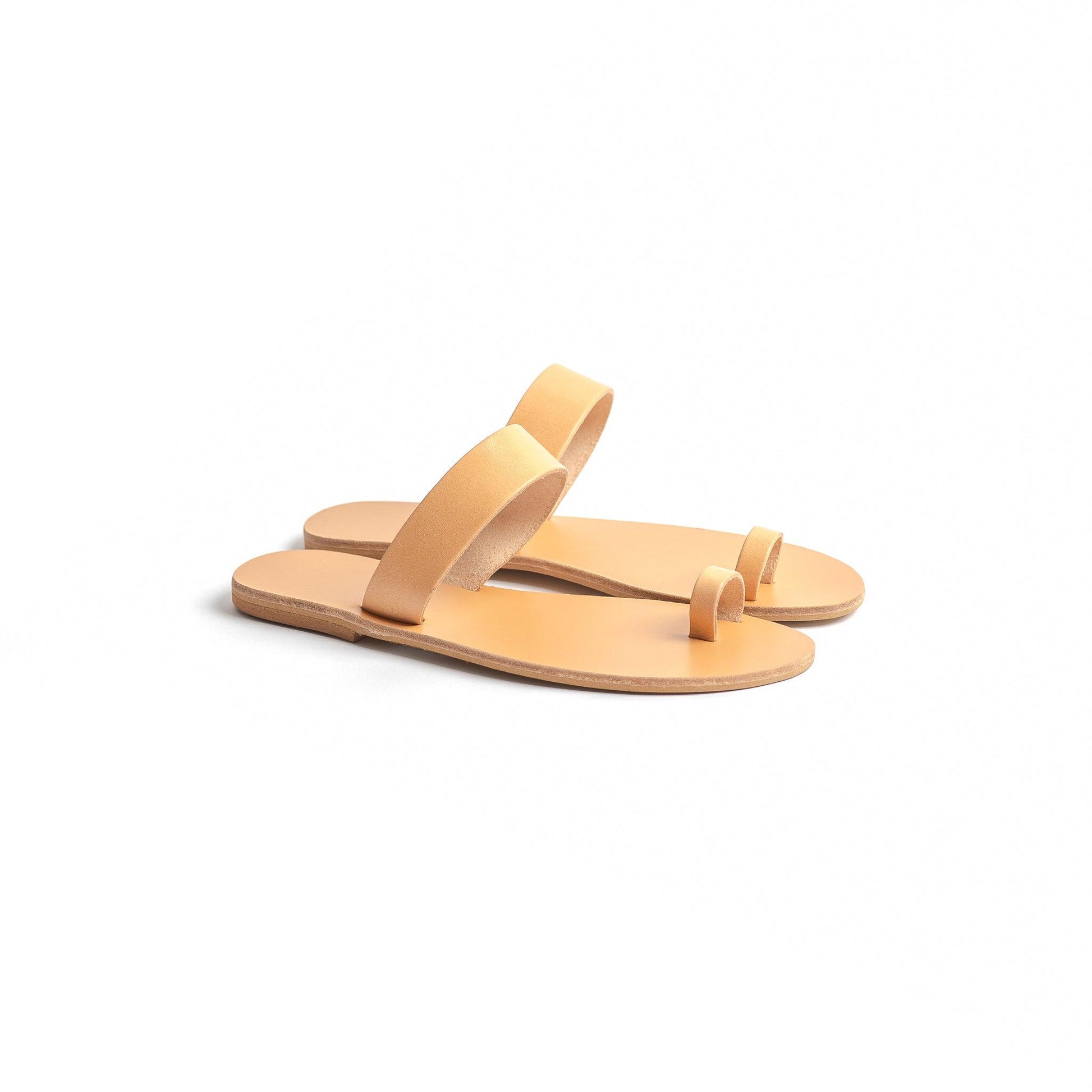 Side view of elegant flat sandals in camel against a white background. Part of our flat footwear for womens collection.