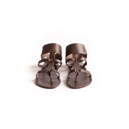 Front view of Athena brown flats against a white background. They are flat sandals with buckle.