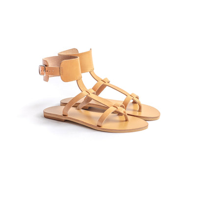 Athena leather flat sandals in tan against a white background. These tan sandals flat are flat sandals buckle.