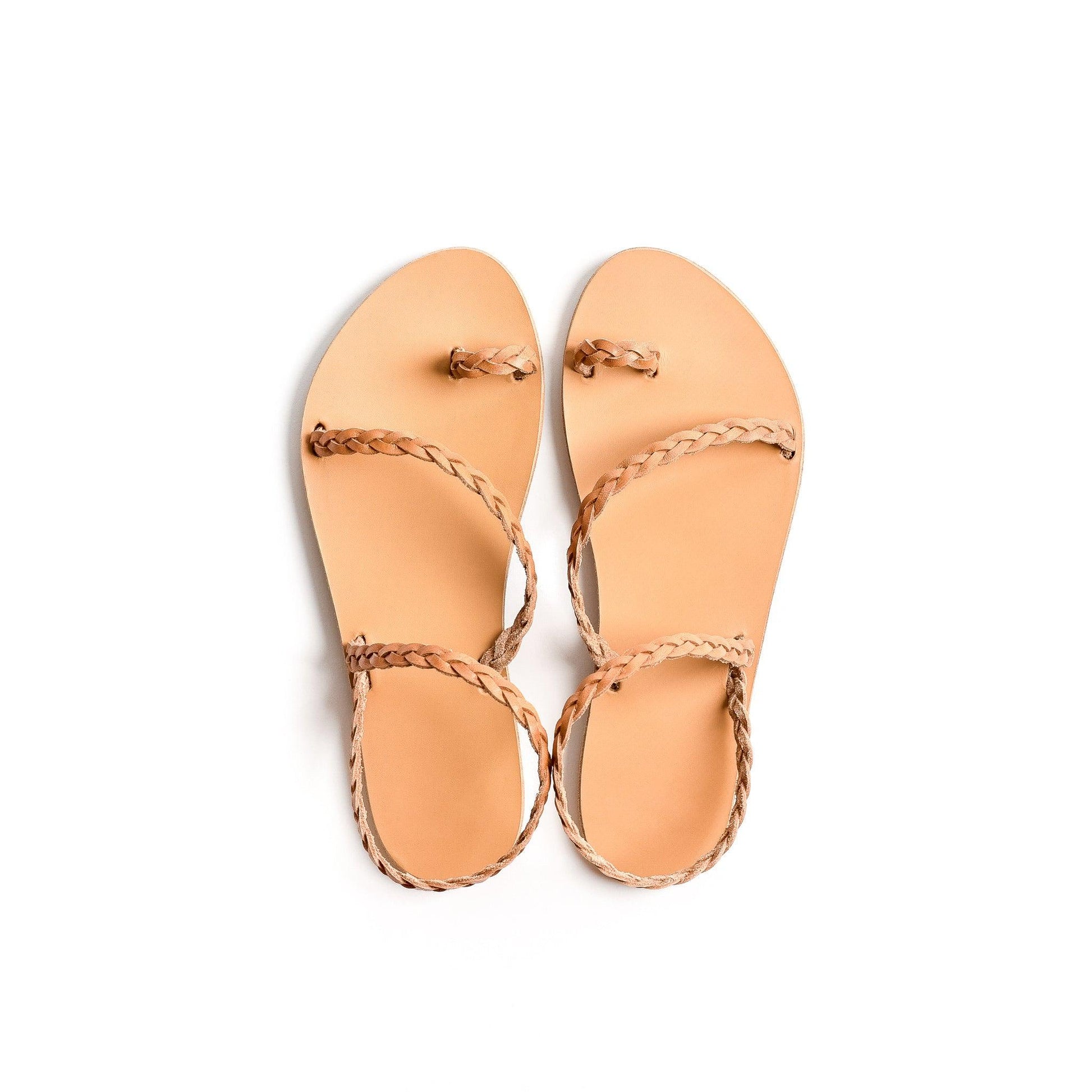 Top view of a pair of tan leather sandals flat for women on a white background. These flat sandals tan are the perfect flat sandals to wear with dresses.