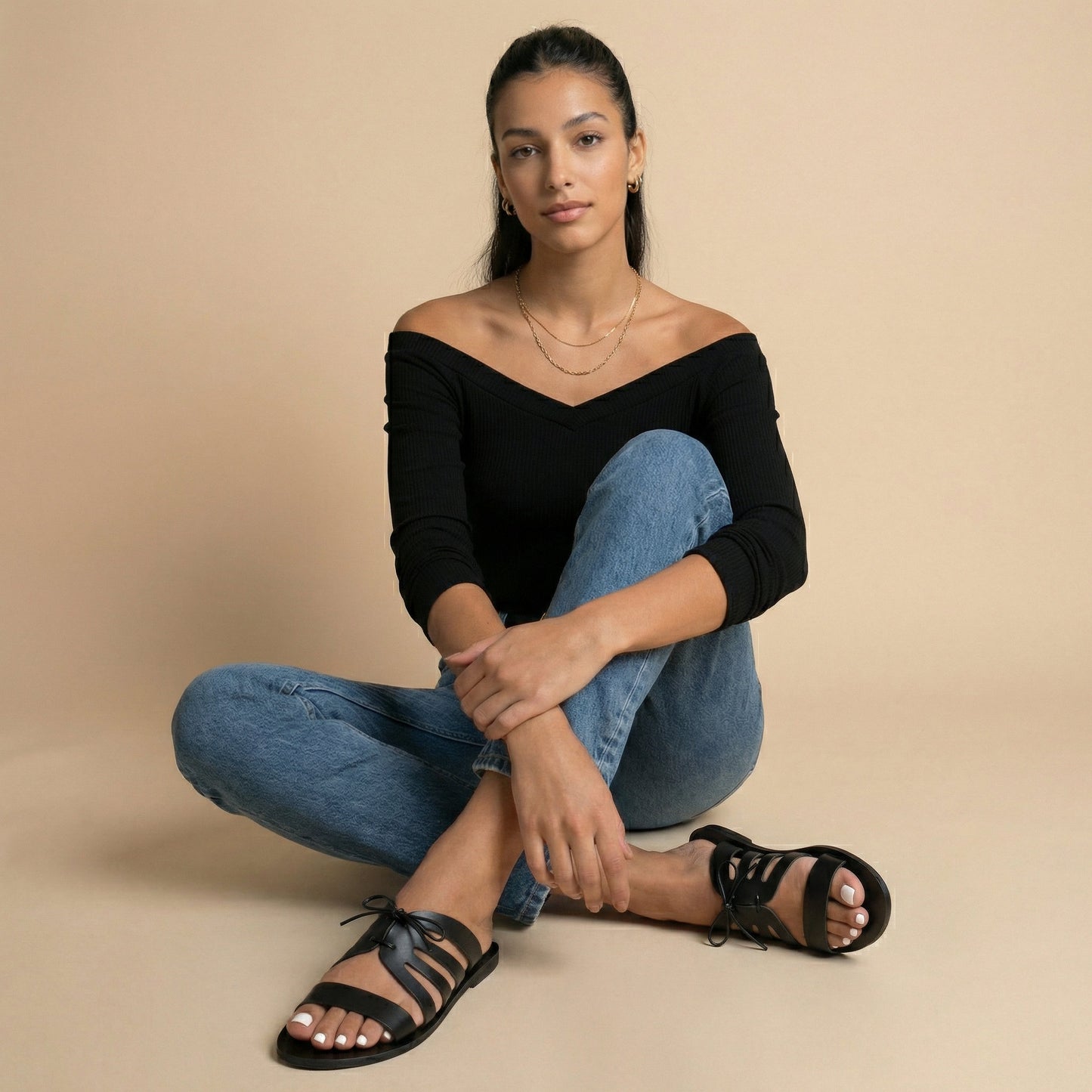 Woman wearing black flats with bow against a white background. These are flat slippers for womens / flat slippers for ladies.