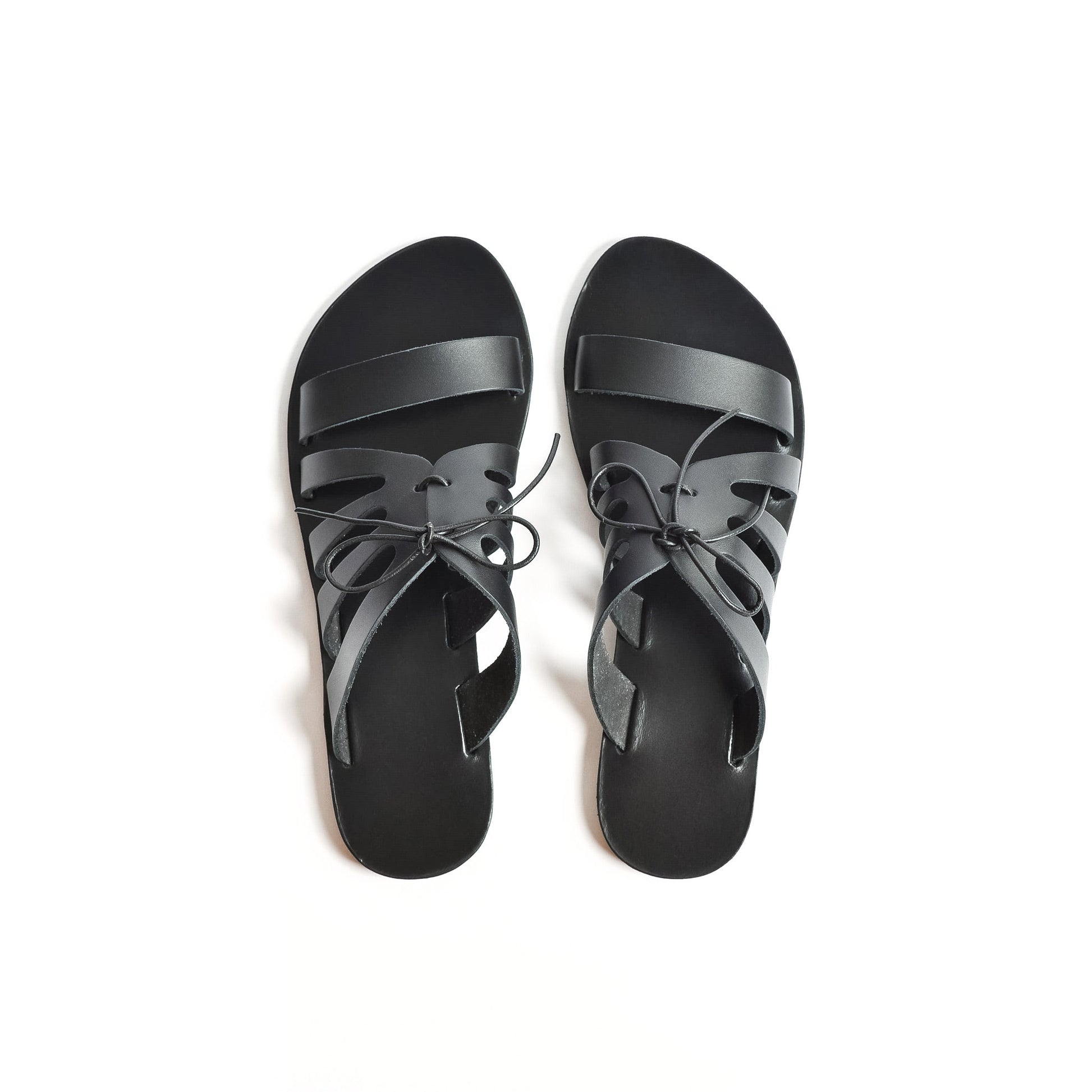 Top view of Chloe black flats with bow shot against a white background. These are flat slippers for womens / flat slippers for ladies.