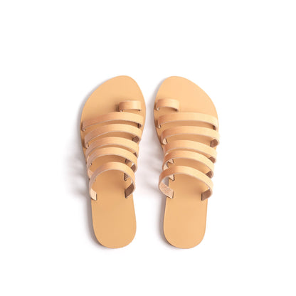 Top view of Harmonia flat sandals open toe in tan against a white background. These are flat sandals without back strap.