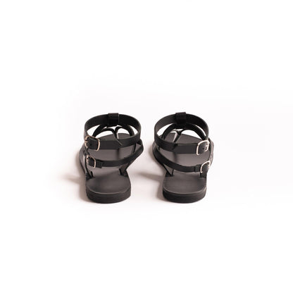 Back view of Rhea black flats for women against a white background.
